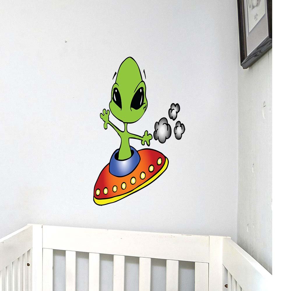 23x24 inch Wall decal of a green alien on a colorful UFO installed above a white crib.