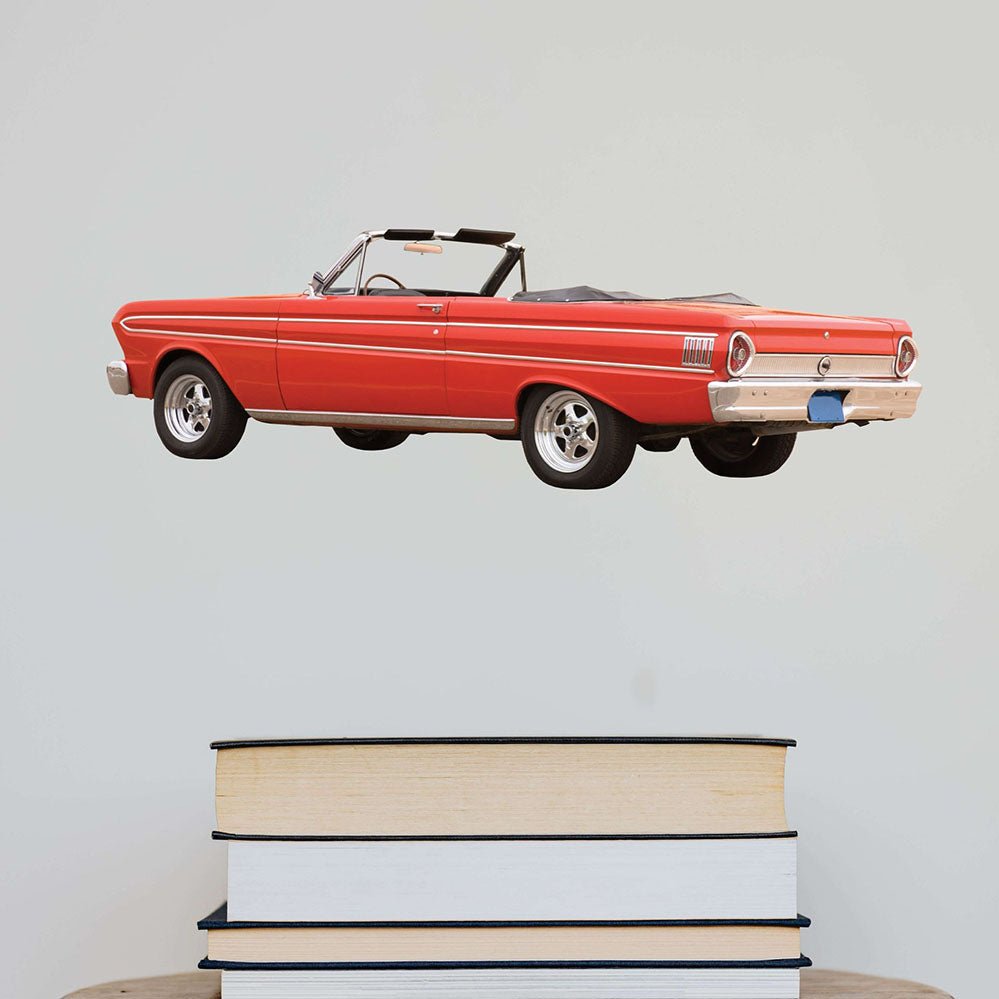 24 inch Red Ford Falcon vintage car decal on a light gray wall above stacked books