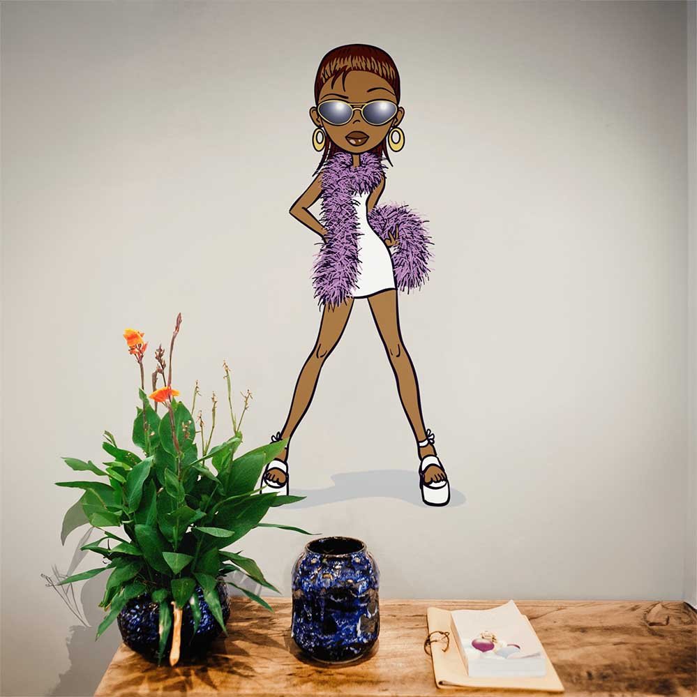 24 inch Diva Brat cartoon character decal with a purple scarf installed above a table with plants and a vase.