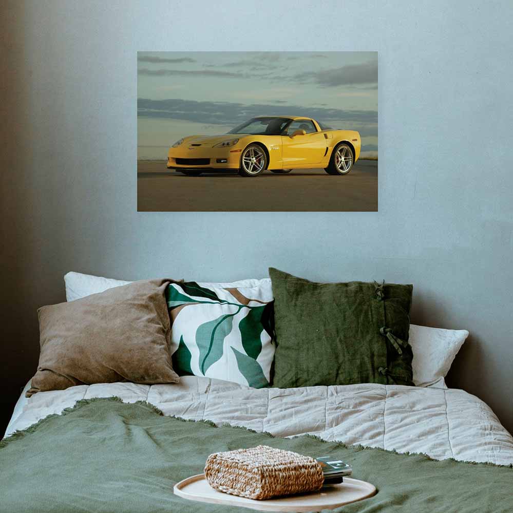 24 inch yellow Corvette Z06 decal above a bed with decorative pillows.