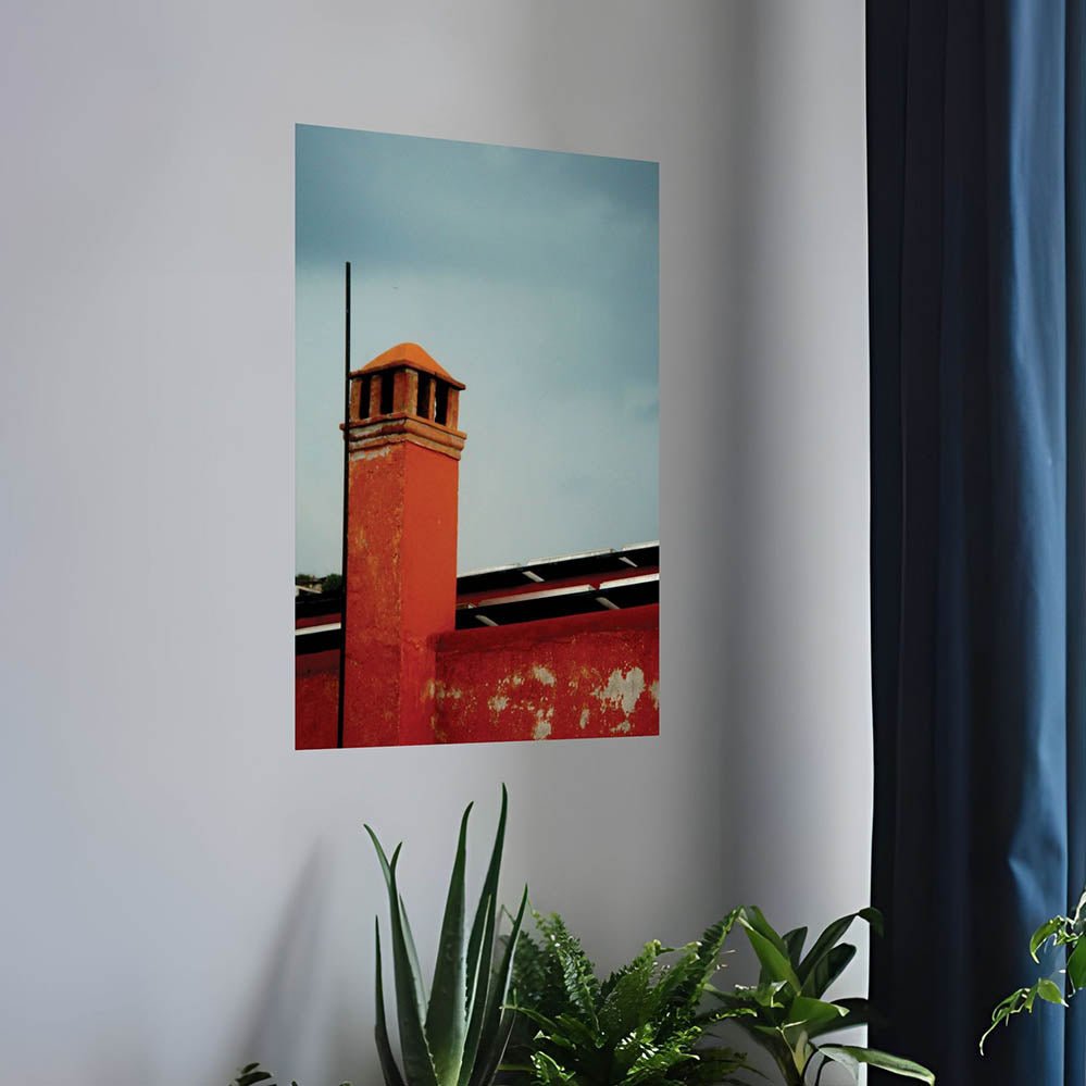 24 inch wall decal of a red brick Mexican building with a chimney installed on a white wall above plants