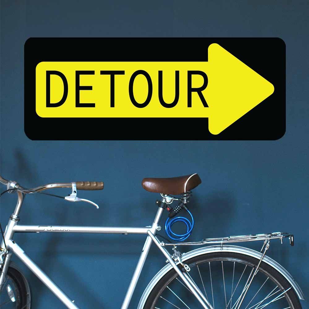 13x36 inch Detour Sign Decal Installed Above Bike Against Wall