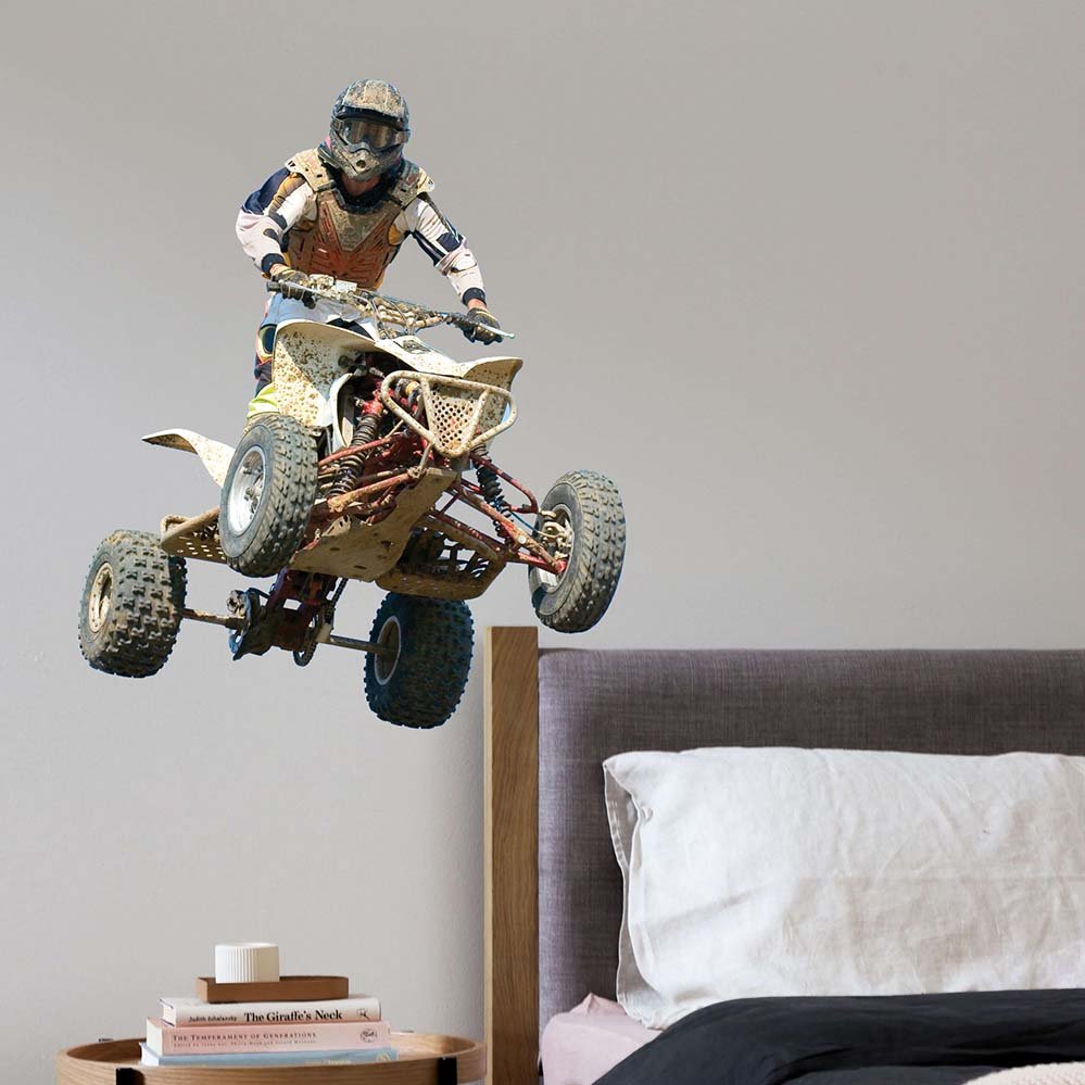 36 inch competitor jumping a quad decal installed above bed and nightstand