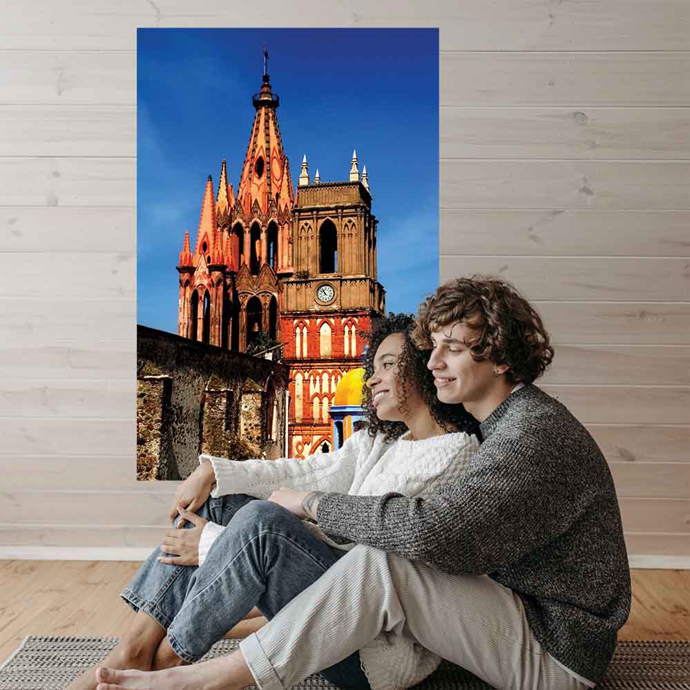 36 inch decal of a colorful Mexican cathedral installed on a wall with two people sitting on floor in foreground