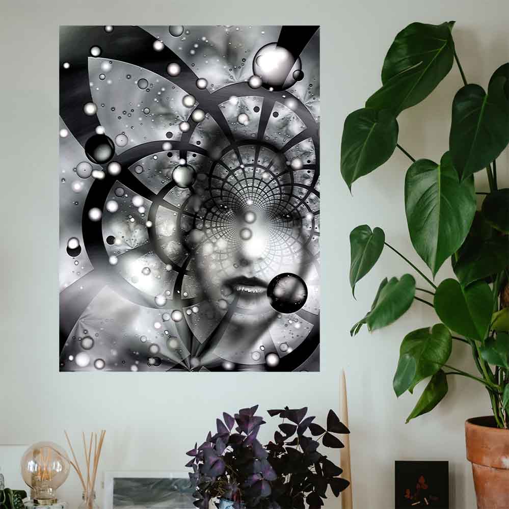 36 inch poster of an abstract black and white fractal artwork features the ghostly visage of a woman emerging from an abstract spiral of cosmic grids, celestial spheres, and radiant particles installed on wall above some potter plants