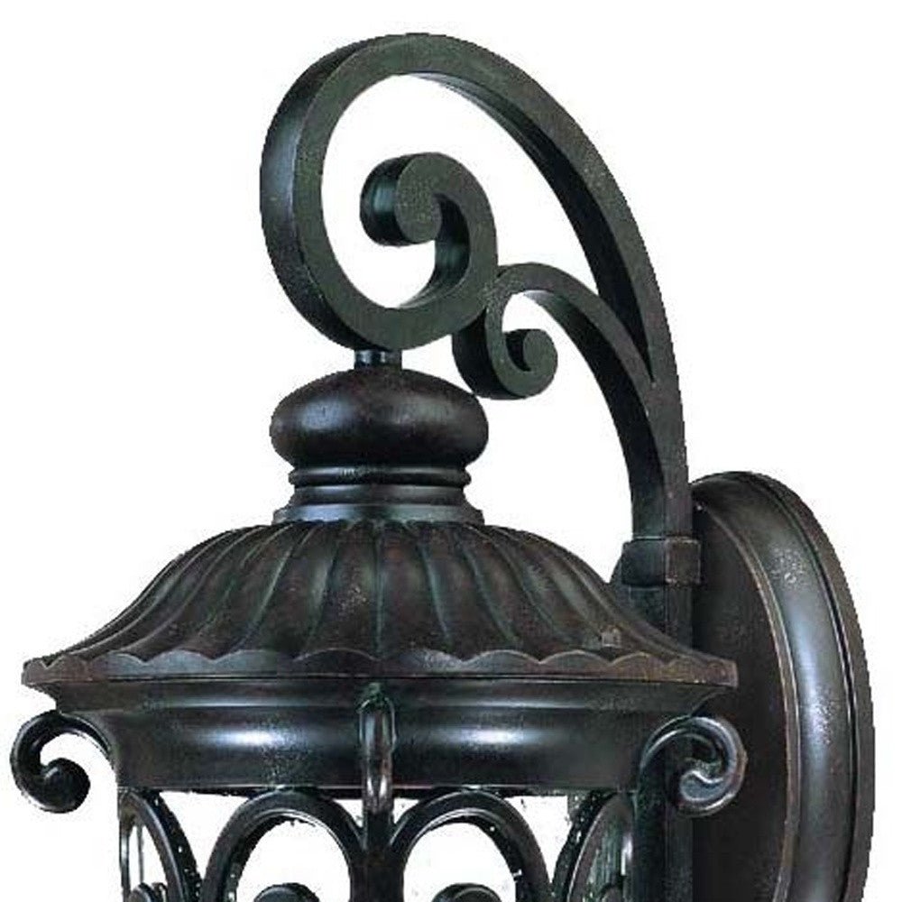 Close up view of the wall plate, scroll arm and top of the Naples 3-Bulb Marbleized Mahogany Outdoor Hanging Wall Light with Seeded Glass