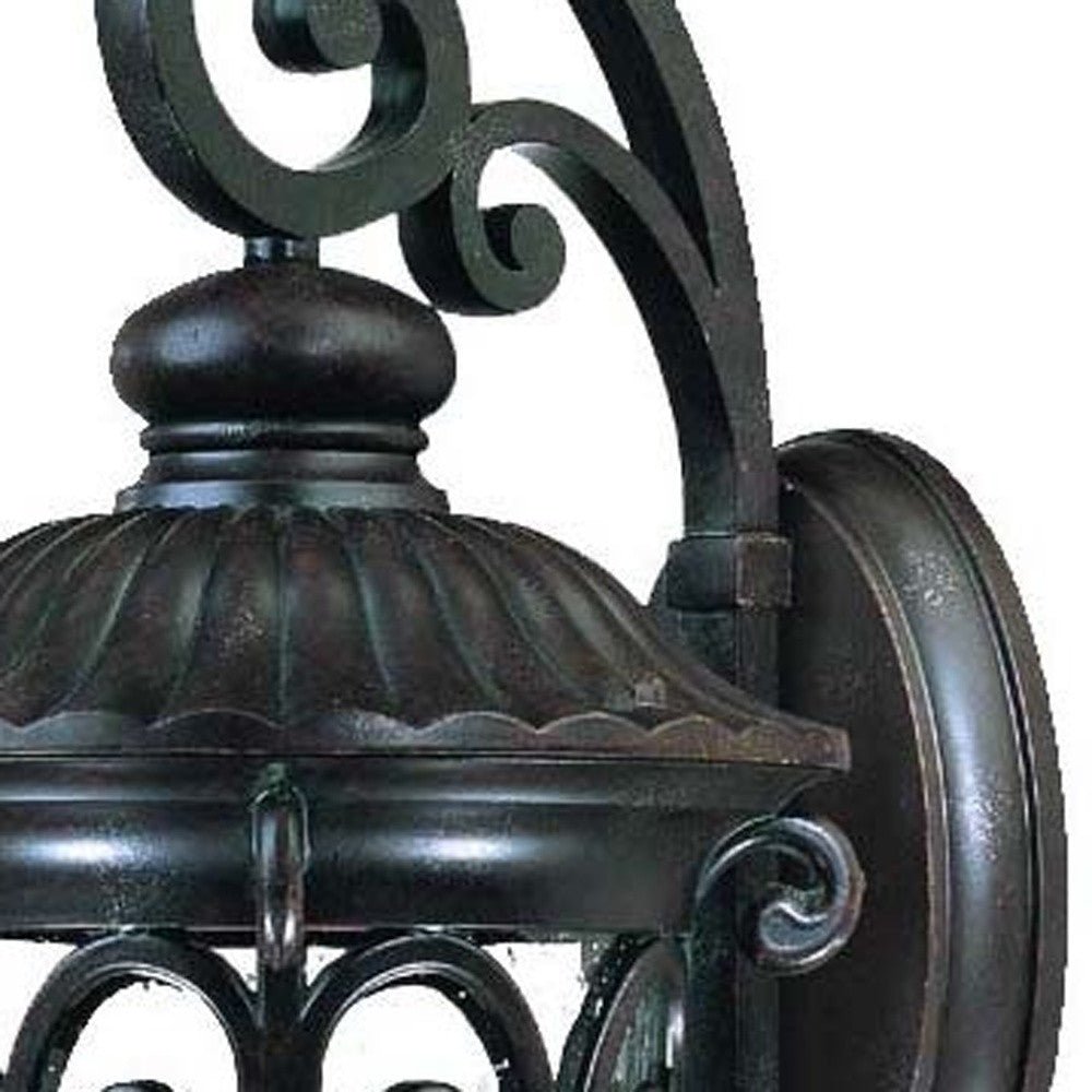 Zoomed in view of the wall plate, framing and scroll arm of the Naples 3-Bulb Marbleized Mahogany Outdoor Hanging Wall Light with Seeded Glass