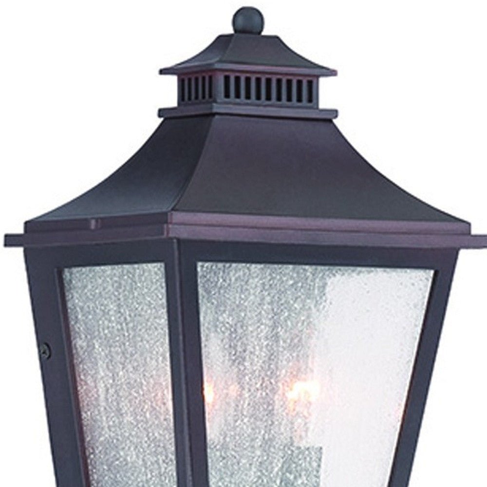Zoomed in view of the top half of the lighted Antique Bronze Two Light Outdoor Pocket Lantern Wall Light with Frosted Glass