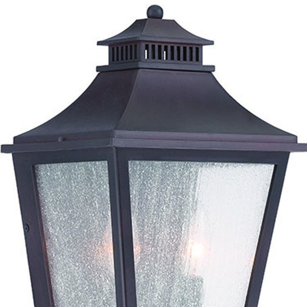 Zoomed in view of the upper half of the lighted XL Antique Bronze Two Bulb Pocket Lantern Wall Light with Frosted Glass