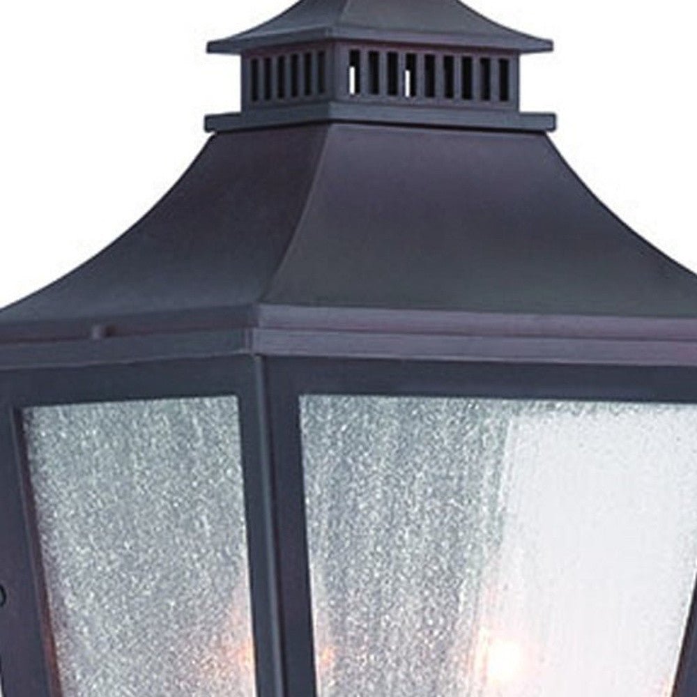 Close up view of the lantern top and glass shade of the lighted XL Antique Bronze Two Bulb Pocket Lantern Wall Light with Frosted Glass