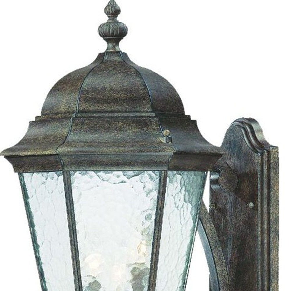 Zoomed in view of the wall plate, top frame and glass shade of the Telfair 3-Bulb Black Coral Outdoor Wall Lantern with Hammered Glass and Traditional Scroll Arm