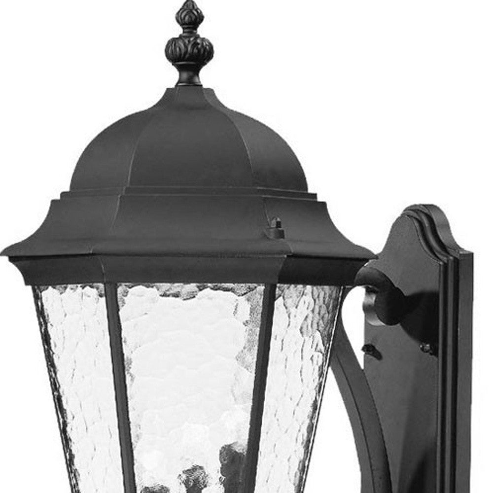 Zoomed in view of the upper half of the Telfair 3-Bulb Matte Black Outdoor Wall Lantern with Hammered Glass and Traditional Design