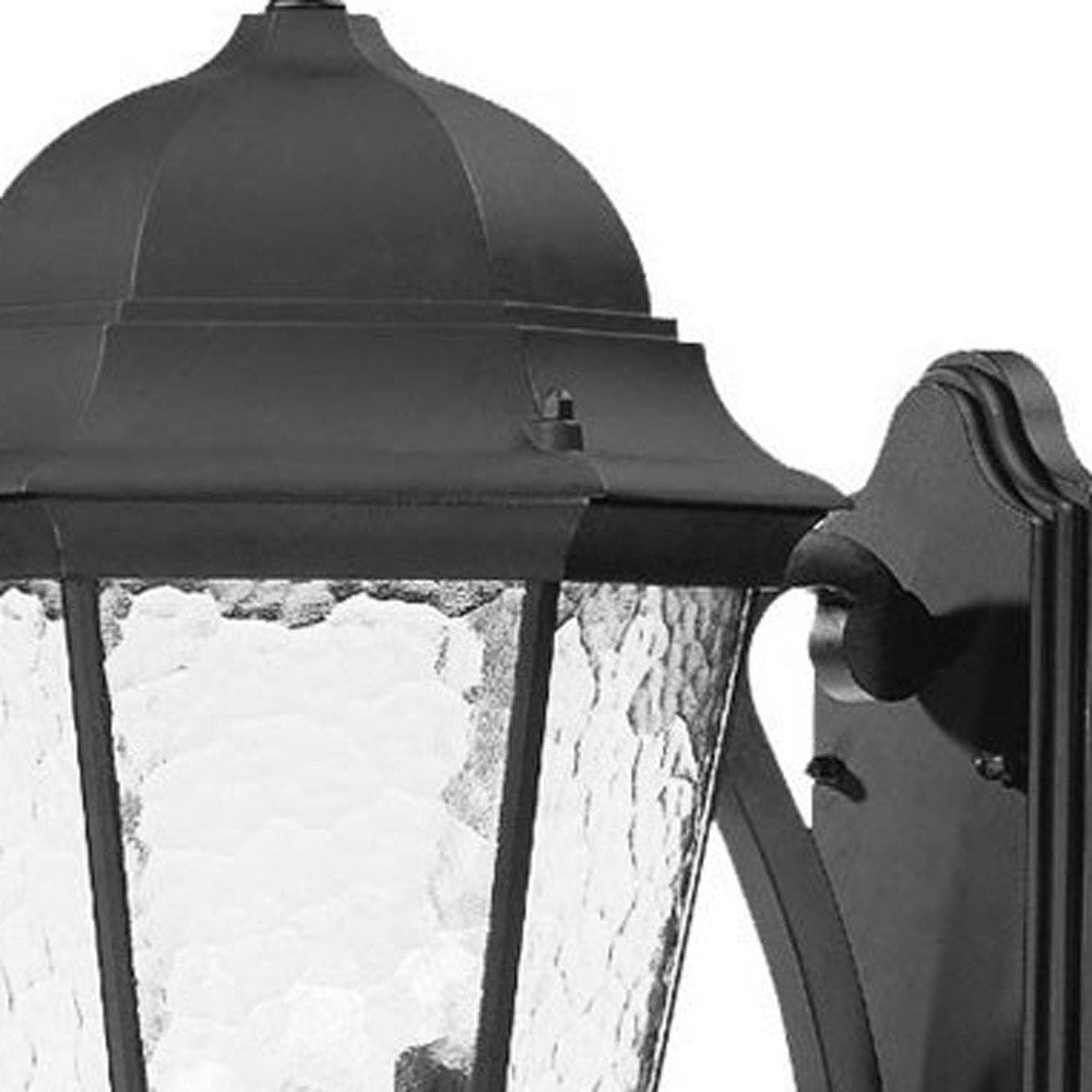 Close up view of the wall plate and lantern top of the Telfair 3-Bulb Matte Black Outdoor Wall Lantern with Hammered Glass and Traditional Design