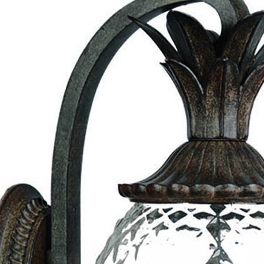 Close up view of the pineapple top of the  Lanai 3-Bulb Black Coral Outdoor Wall Lantern with Pineapple Design and Textured Glass