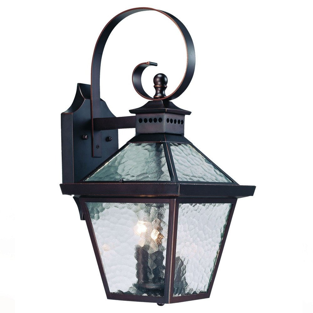 Front left angle view of the lighted Bay Street Triple-Light Architectural Bronze Outdoor Wall Lantern with Hammered Glass