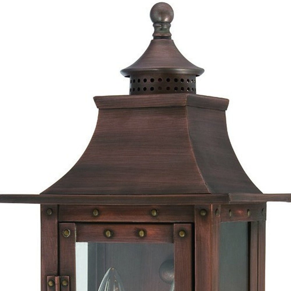 Zoomed in view of the upper half of the lighted St. Charles 2-Bulb Copper Patina Colonial Outdoor Wall Lantern Light