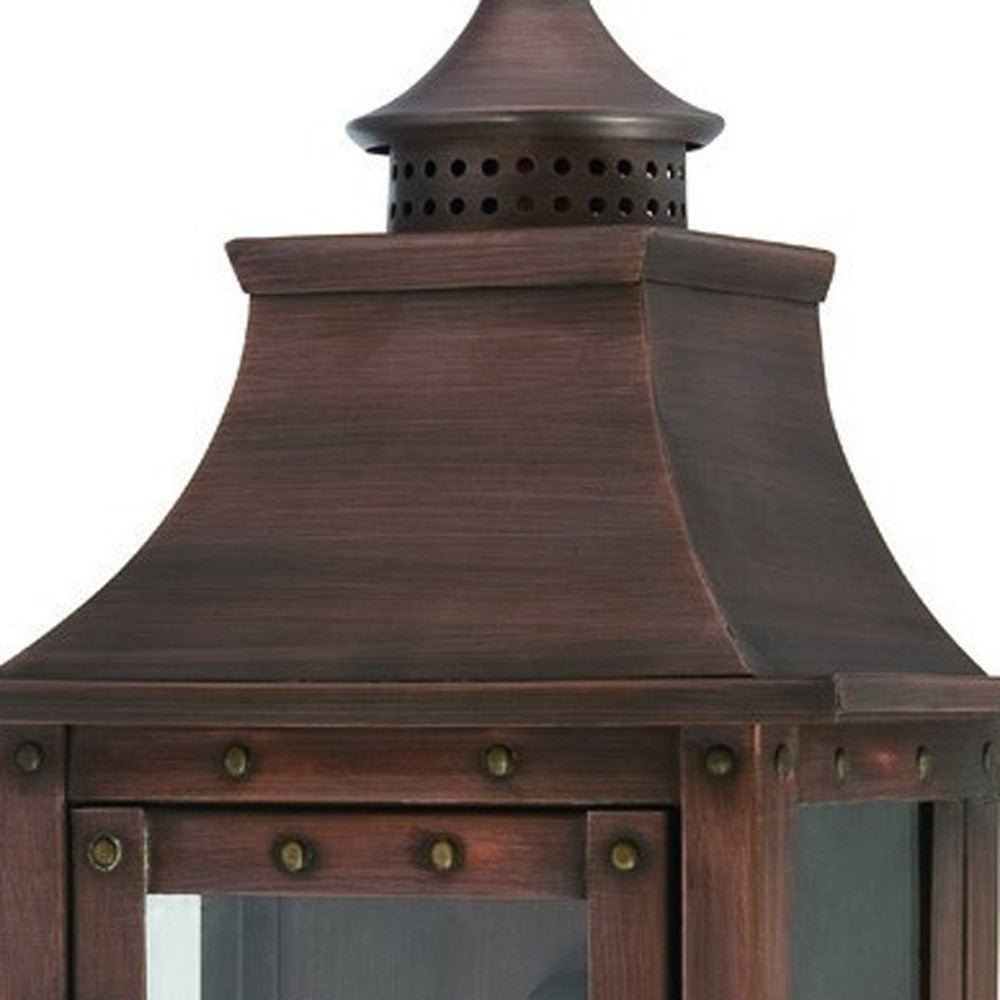 Zoomed in view of the lantern top with rivets of the lighted St. Charles 2-Bulb Copper Patina Colonial Outdoor Wall Lantern Light