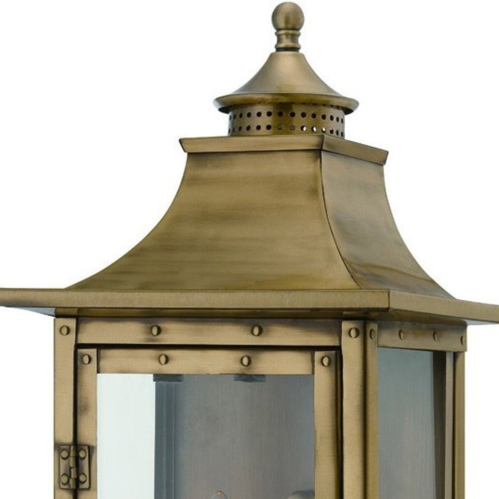 Zoomed in view of the lantern top of the lighted St. Charles 2-Bulb Aged Brass Colonial Outdoor Wall Lantern Light 10x20
