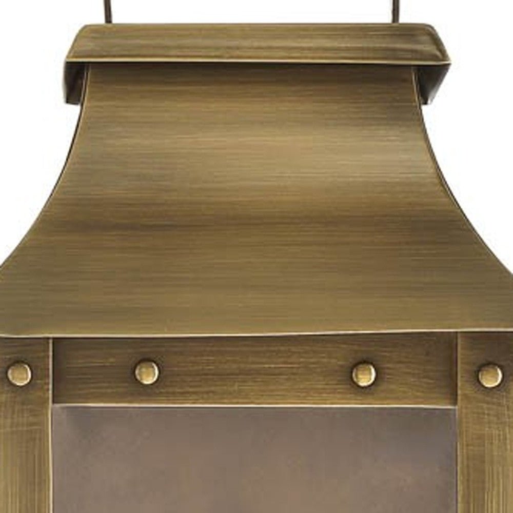 Zoomed in view of the fixture top with rivets of the lighted Manchester 1-Bulb Aged Brass Pocket Wall Light with clear glass and solid brass frame – outdoor lantern style wall sconce