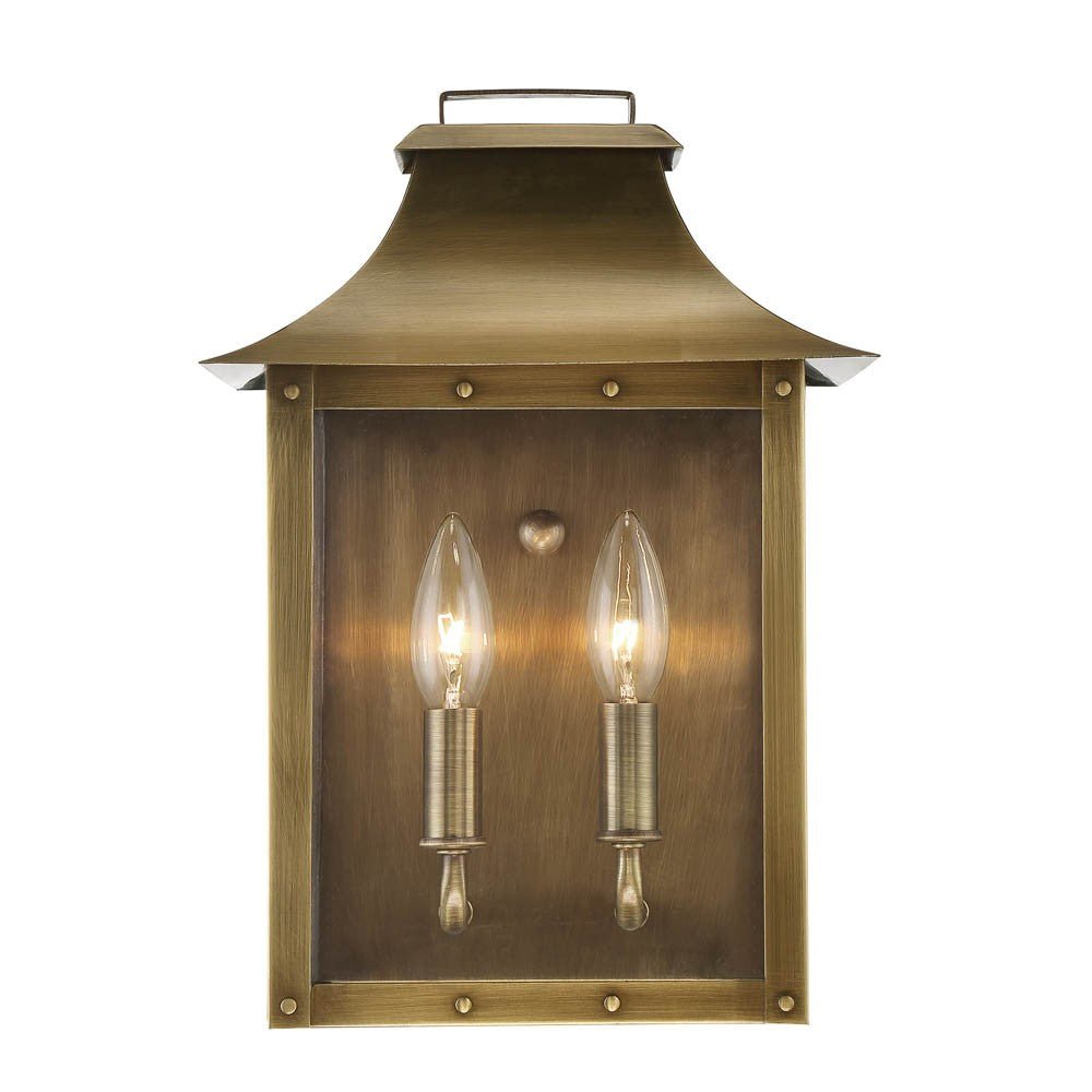 Front view of the lighted Manchester 2-Bulb Aged Brass Pocket Wall Lantern with Clear Glass – Outdoor Rustic Brass Lighting Fixture