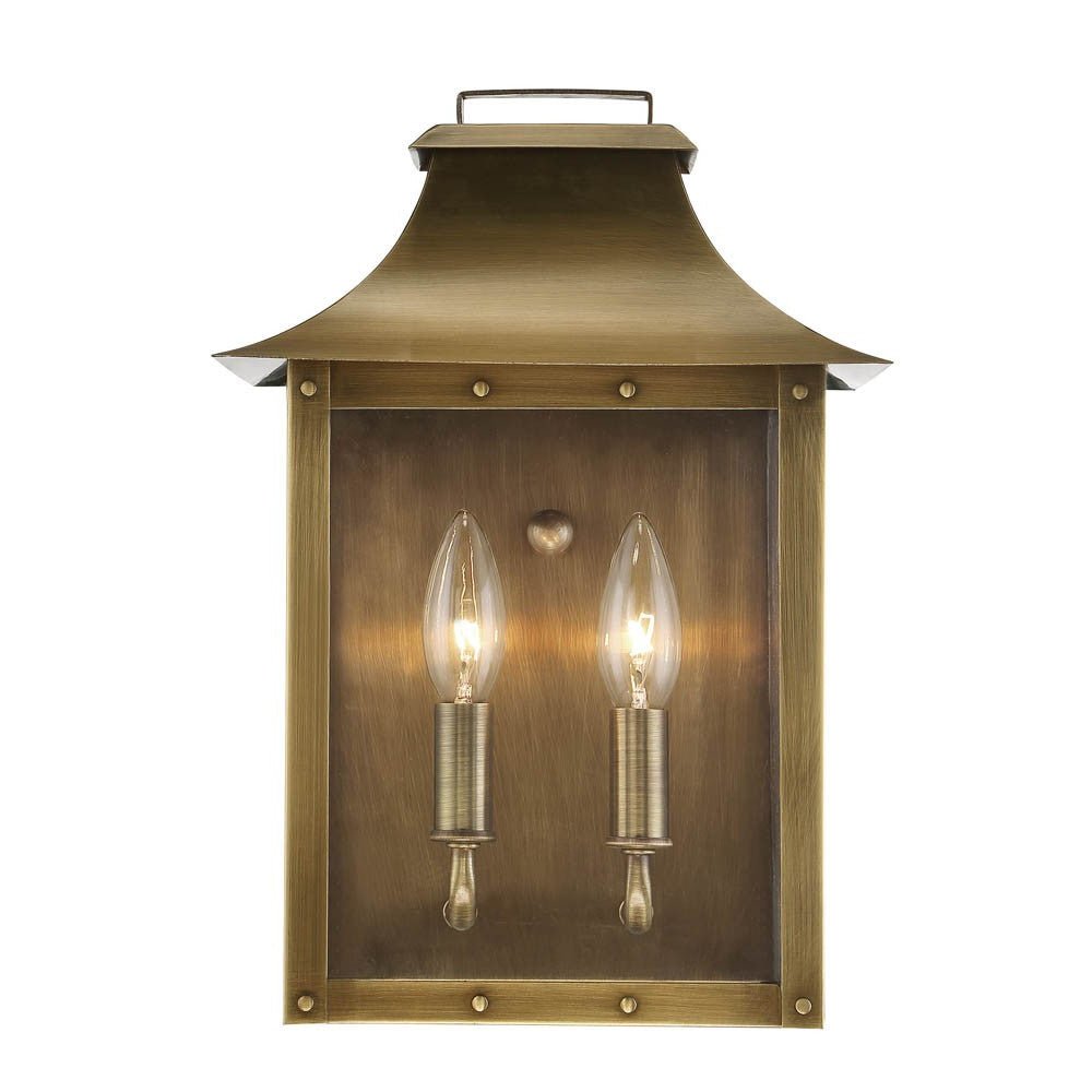 Zoomed in front view of the lighted Manchester 2-Bulb Aged Brass Pocket Wall Lantern with Clear Glass – Outdoor Rustic Brass Lighting Fixture