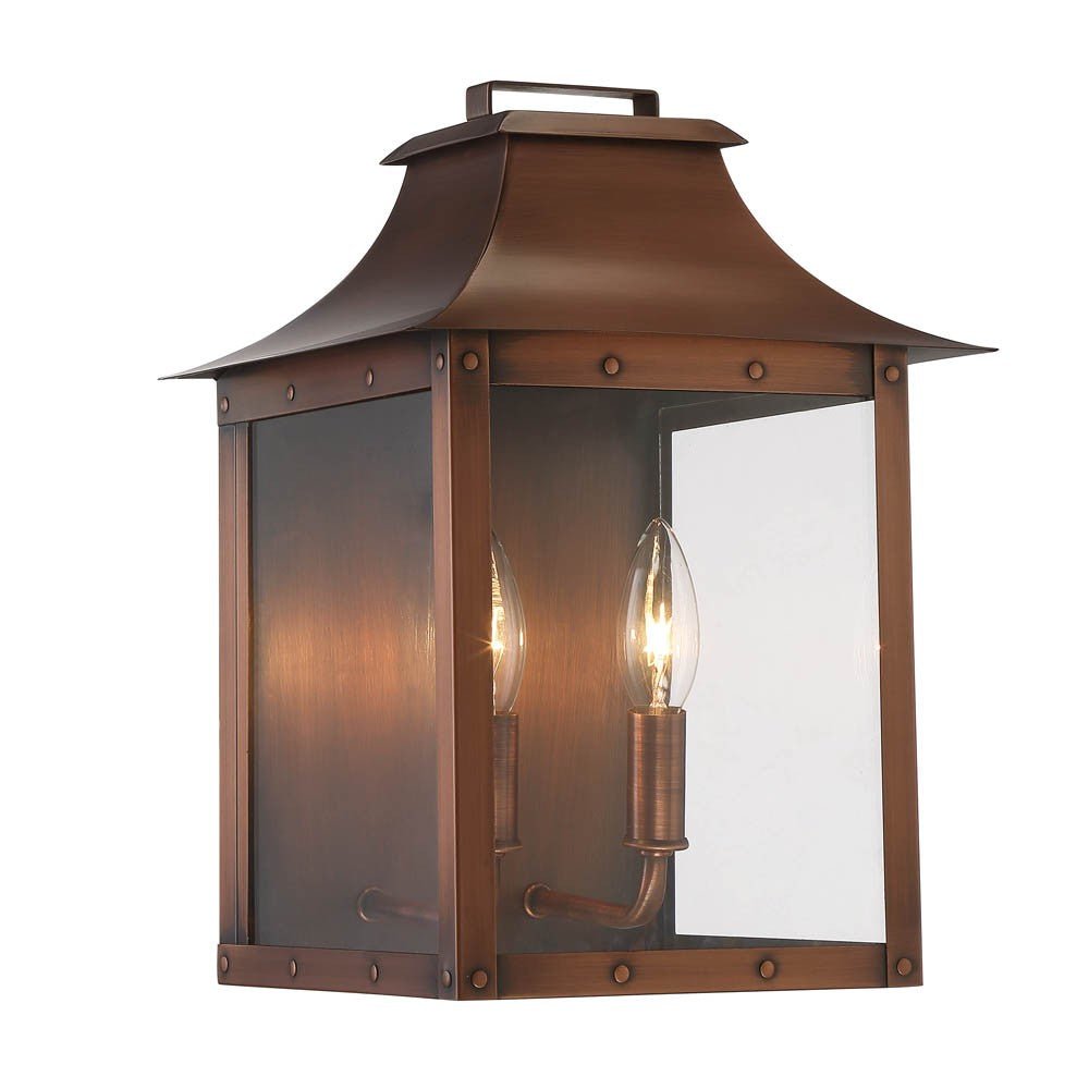 Front left angle view of the lighted Manchester 2-Bulb Copper Patina Pocket Wall Lantern with Clear Glass – Rustic Outdoor Lighting Fixture