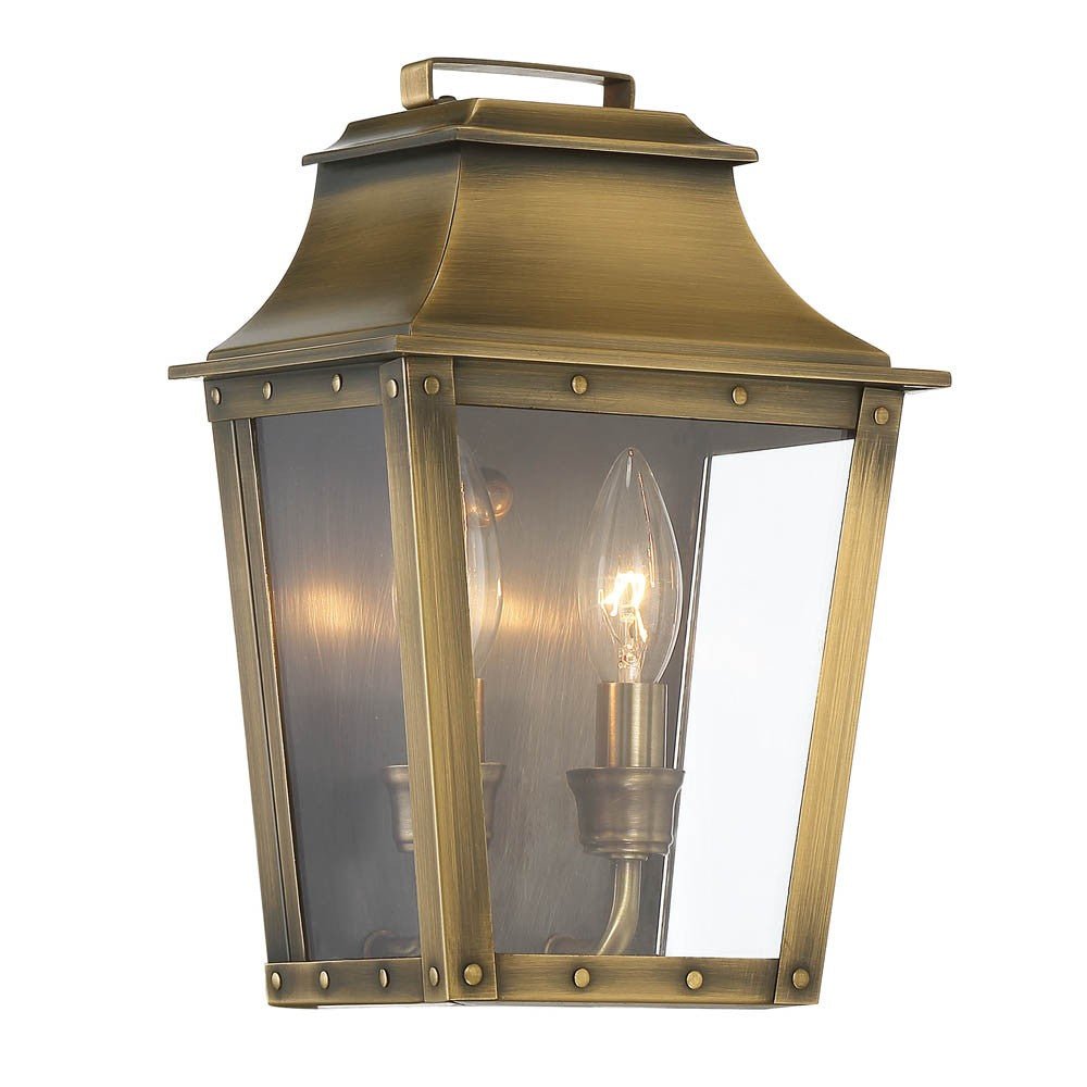 Front left angle view of the lighted Coventry 2-Bulb Aged Brass Pocket Wall Lantern with Clear Glass – Indoor Outdoor Lighting Fixture