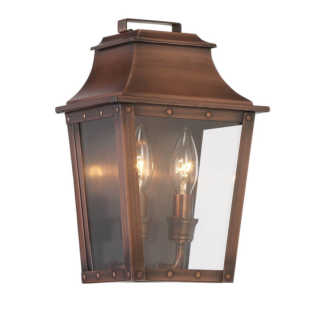 Front left angle view of the lighted Coventry 2-Bulb Copper Patina Pocket Wall Lantern with Clear Glass – Outdoor Indoor Lighting Fixture