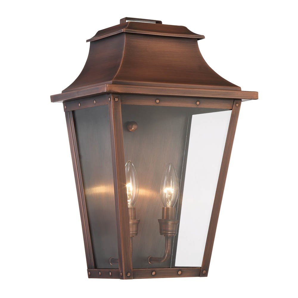 Front left angle view of the lighted Coventry 2-Bulb Copper Patina Pocket Wall Lantern with Clear Glass Panels – Outdoor Indoor Lighting Fixture