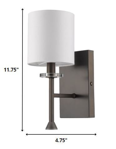 Minimalist Bronze Wall Sconce with White Fabric Shade and Crystal Bobeche Accent shown with dimensions of 11 point 75 inches high by 4 point 75 inches wide