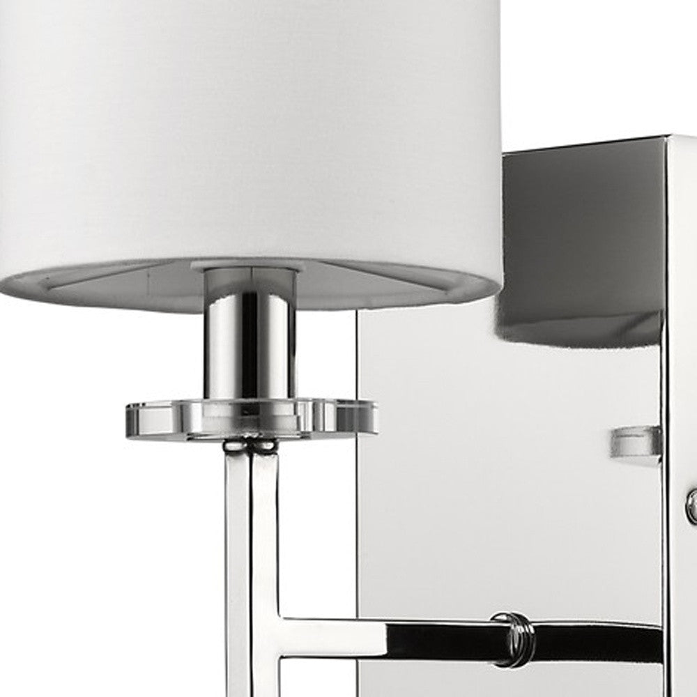 Zoomed in view of the square wall plate, angled arm and base of fixture of the Minimalist Silver Wall Sconce with White Fabric Shade and Crystal Bobeche Accent