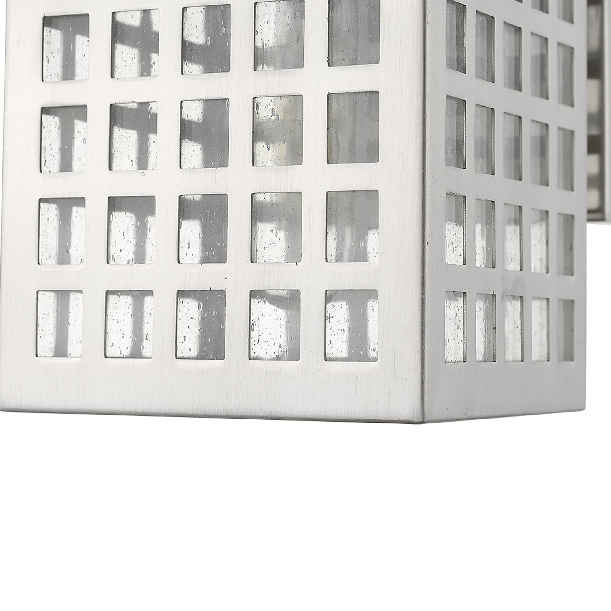 Zoomed in view of the metal frame and glass shade of the Letzel Satin Nickel Outdoor Wall Lantern with Modern Grid Design and Clear Seedy Glass