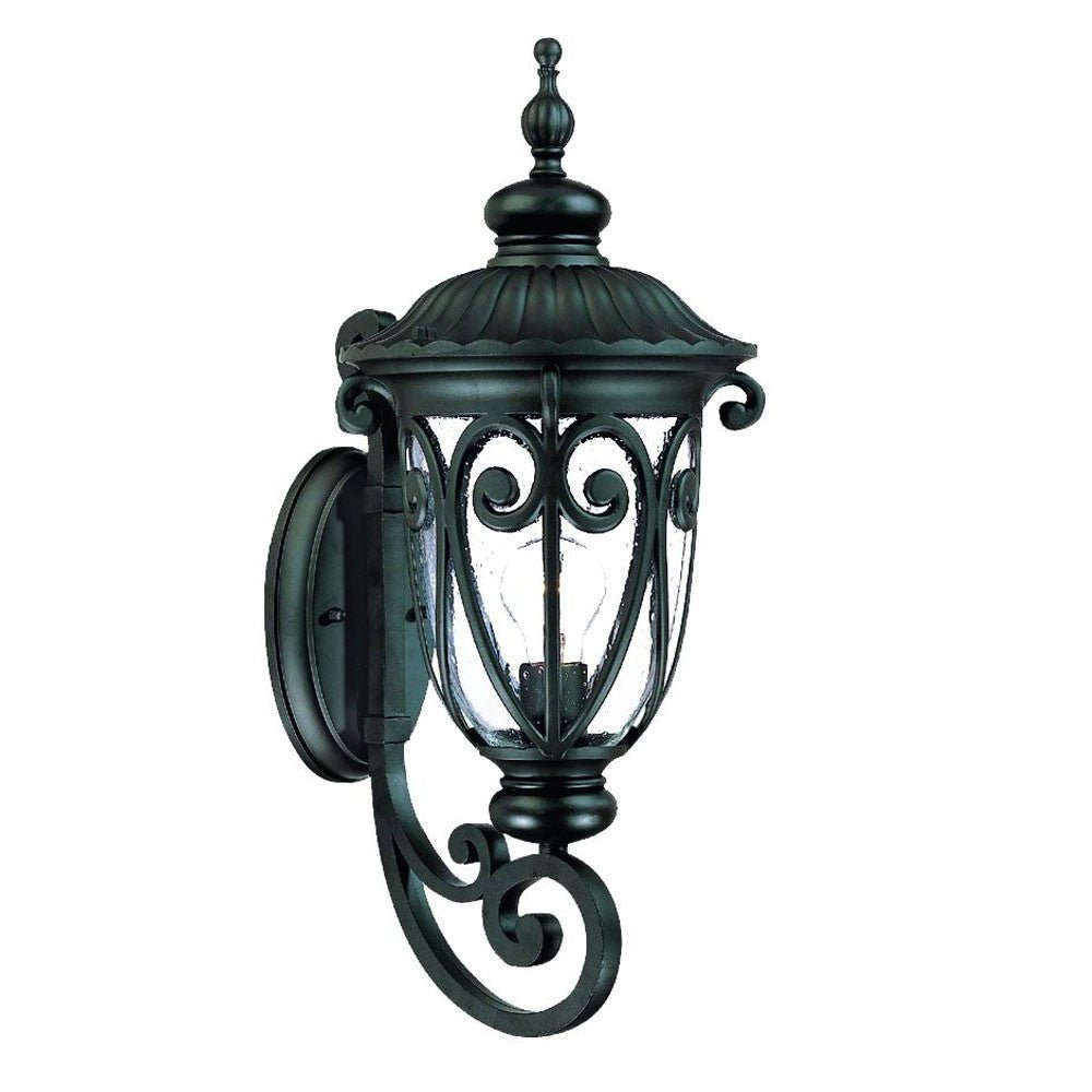 Left side angled view of the Naples Matte Black Outdoor Wall Lantern with Seeded Glass and Scroll Design
