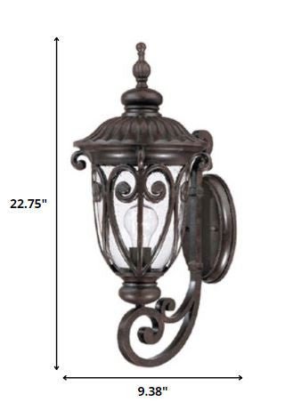 marbelized mahogany outdoor wall lantern sconce with ornate cast aluminum frame and clear seeded glass for porch or entryway lighting shown with dimensions of 22 point 75 inches high by 9 point 38 inches wide