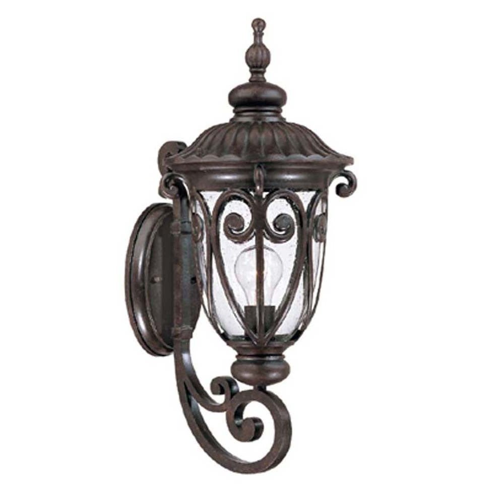 Left side angled view of the marbelized mahogany outdoor wall lantern sconce with ornate cast aluminum frame and clear seeded glass for porch or entryway lighting