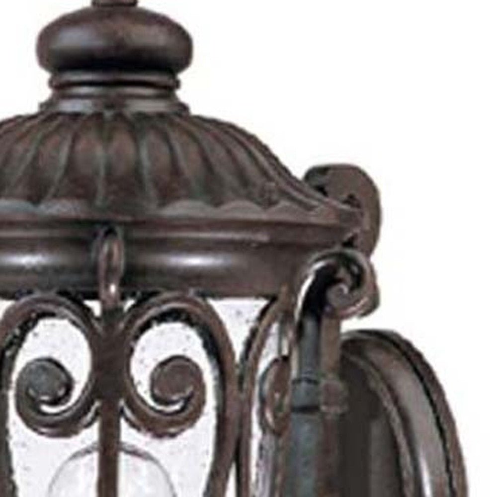 Zoomed in view of the frame and glass of the marbelized mahogany outdoor wall lantern sconce with ornate cast aluminum frame and clear seeded glass for porch or entryway lighting