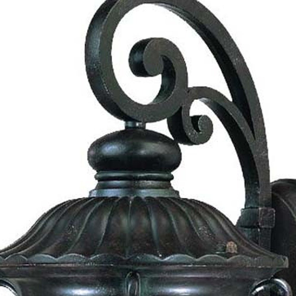 Zoomed in view of the fixture top of the Naples marbleized black outdoor wall light with ornate scrollwork and seeded glass panels