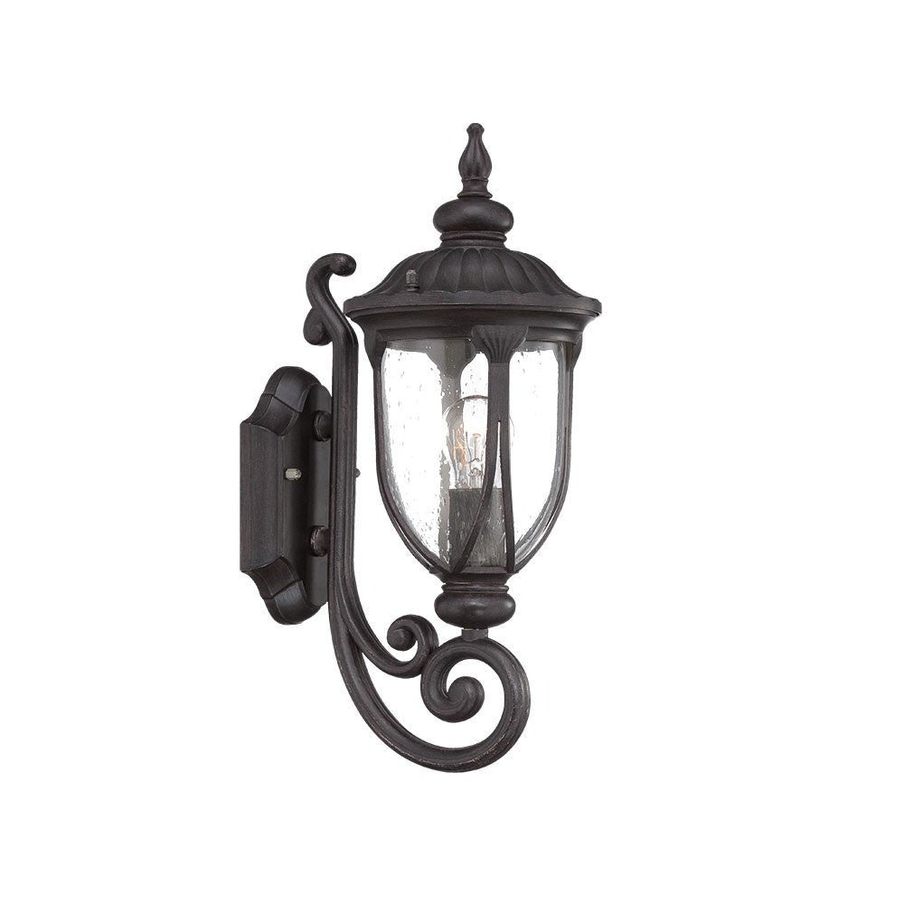 Left side angled view of the lighted Black cast aluminum outdoor glass lantern wall light with curved shield silhouette