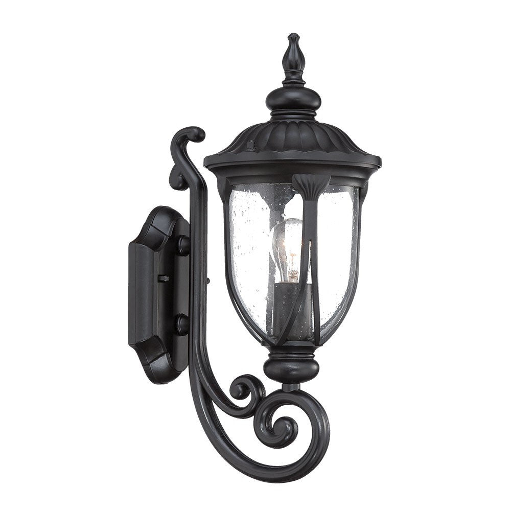 Left side angled view of the lighted Matte black cast aluminum outdoor glass lantern wall light with clear panels