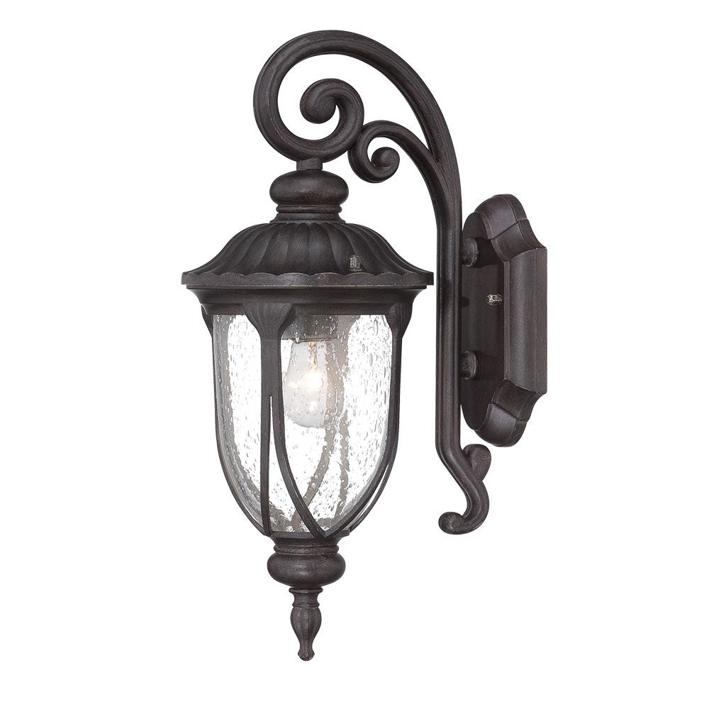Right side angled view of the lighted Black cast aluminum outdoor glass lantern wall sconce with clear panels