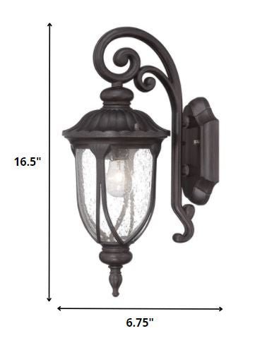Black cast aluminum outdoor glass lantern wall sconce with clear panels shown with dimensions of 16 point 5 inches high by 6 point 75 inches wide