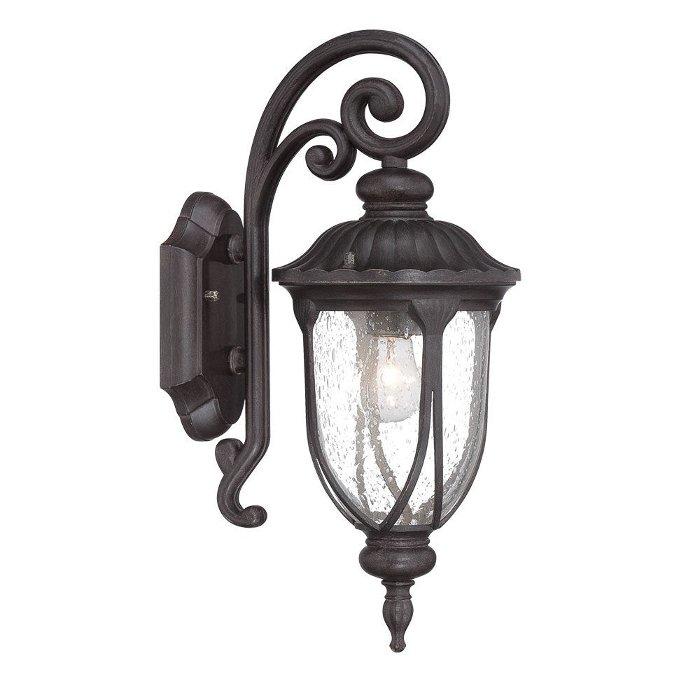 Left side angled view of the lighted Black cast aluminum outdoor glass lantern wall sconce with clear panels