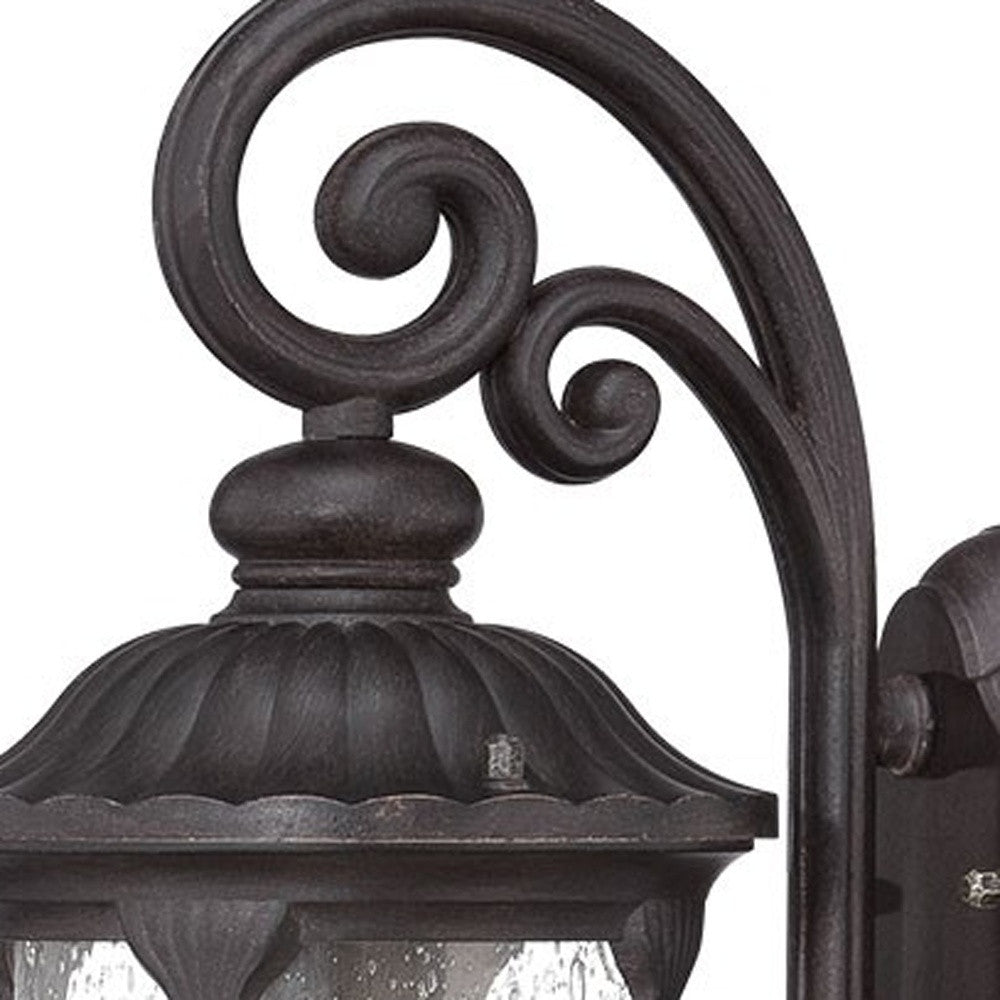 Zoomed in view of the fixture top of the  lighted Black cast aluminum outdoor glass lantern wall sconce with clear panels