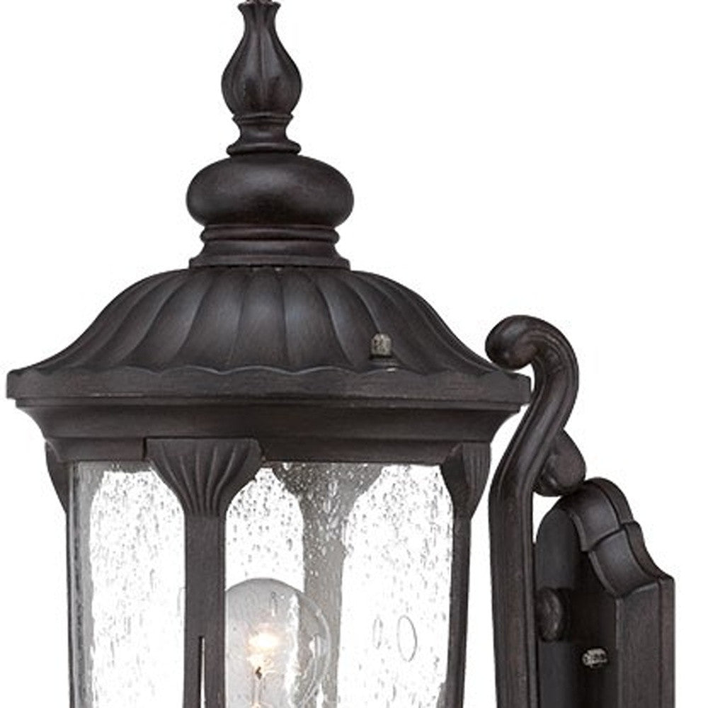 Zoomed in view of the lantern top of the lighted XL black cast aluminum standing lantern outdoor wall light with clear glass panels