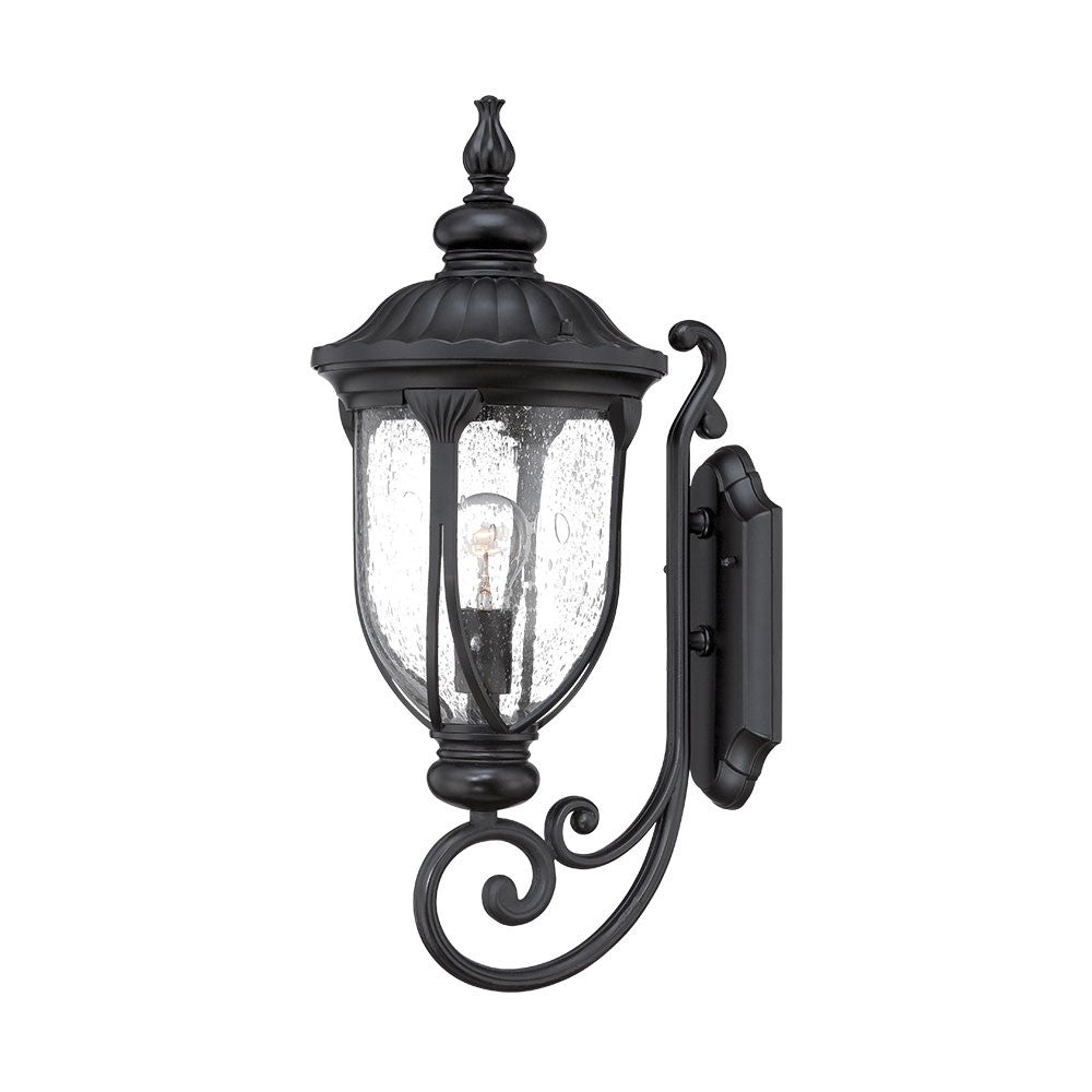 Right side angled view of the lighted XL matte black cast aluminum standing lantern outdoor wall light with clear glass panels