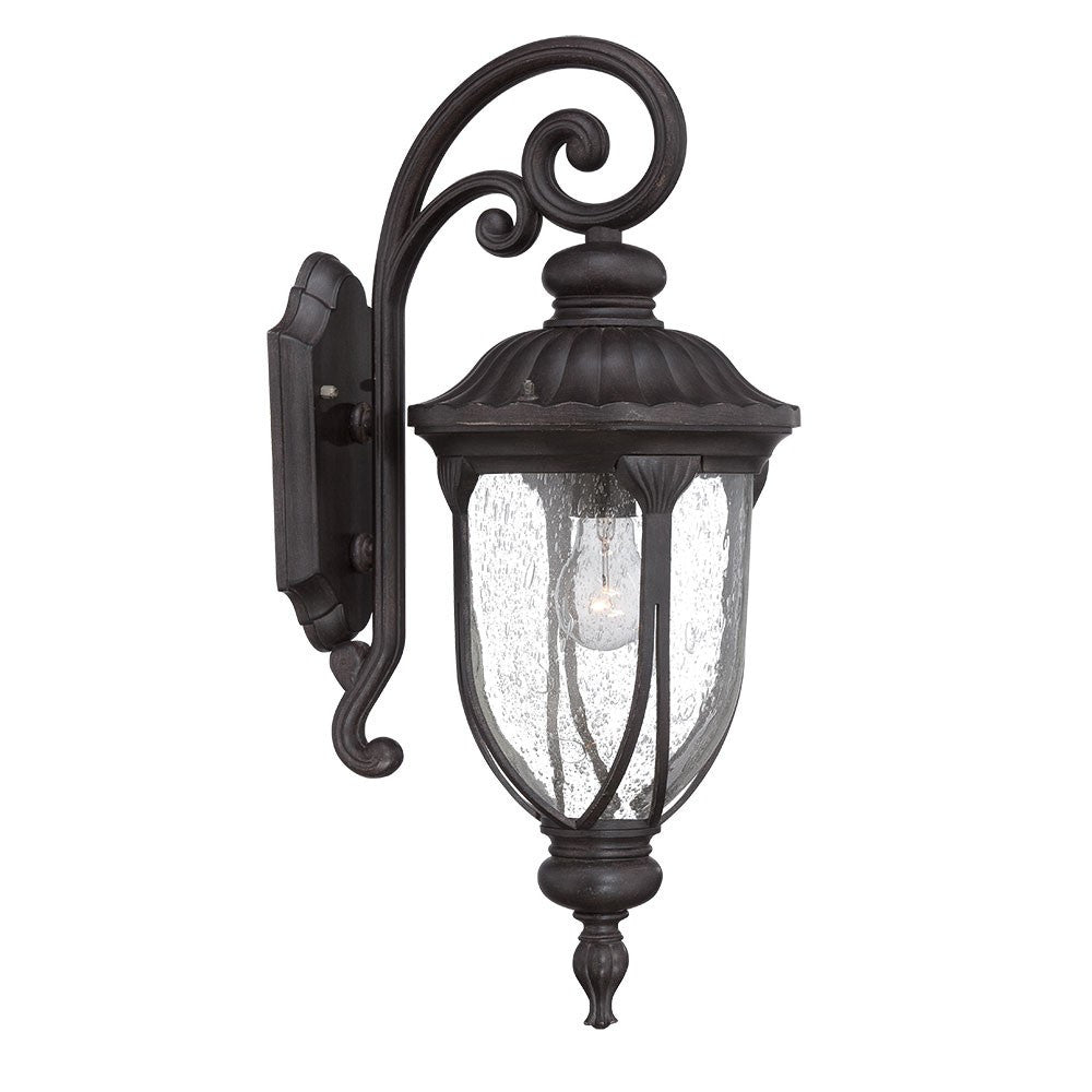 Left side angled view of the lighted XL black cast aluminum outdoor hanging lantern wall sconce with clear glass panels