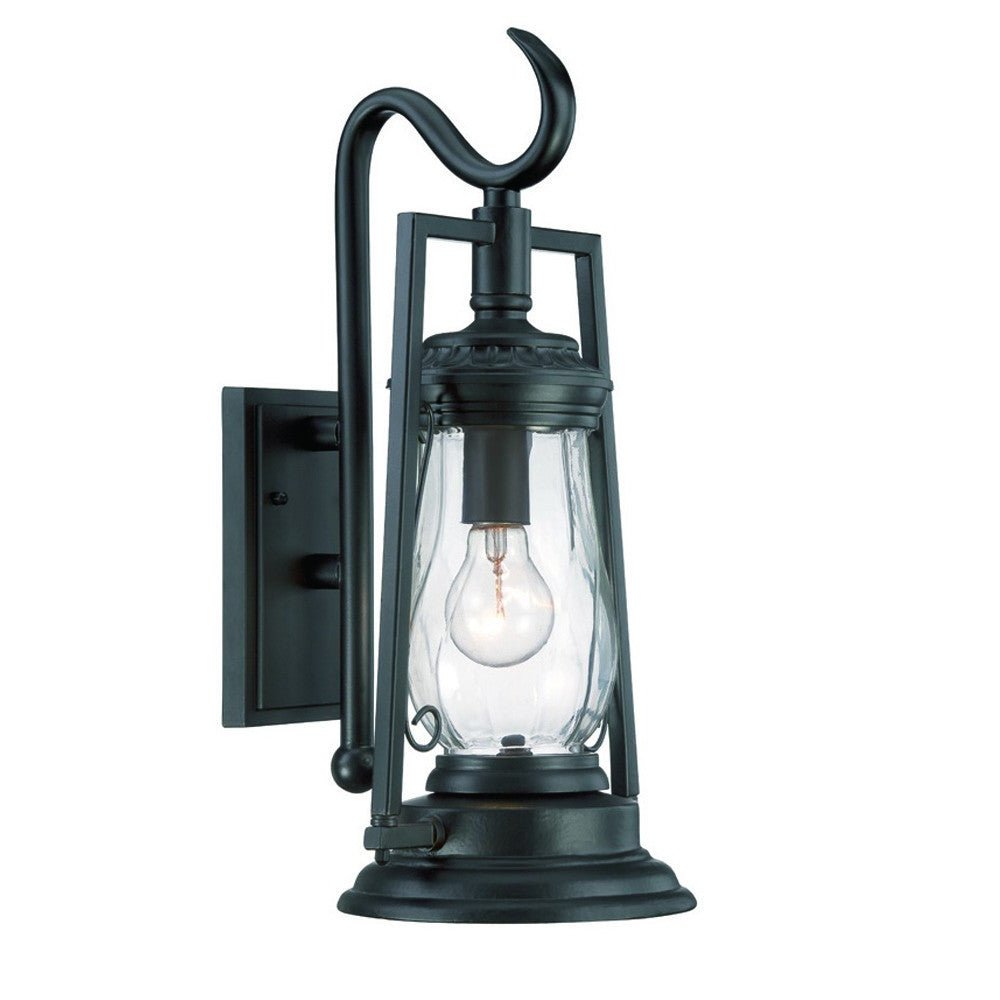 Left side angled view of the lighted Matte black oil lamp-inspired outdoor wall light with clear glass shade