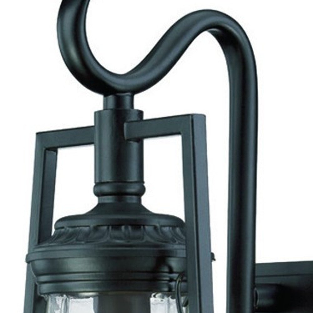 Zoomed in view of the fixture top of the Matte black oil lamp-inspired outdoor wall light with clear glass shade