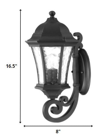 Matte black tapered outdoor lantern wall light with hammered glass panels shown with dimensions of 16 point 5 inches high by 8 inches wide