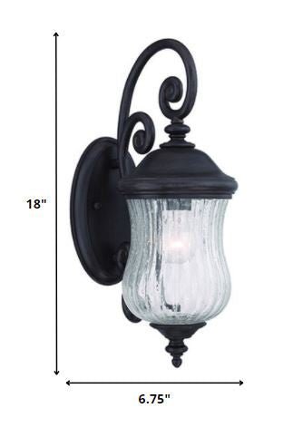 Matte Black urn shaped outdoor wall light with raindrop glass globe mounted on wall shown with dimensions of 18 inches high by 6 point 75 inches wide